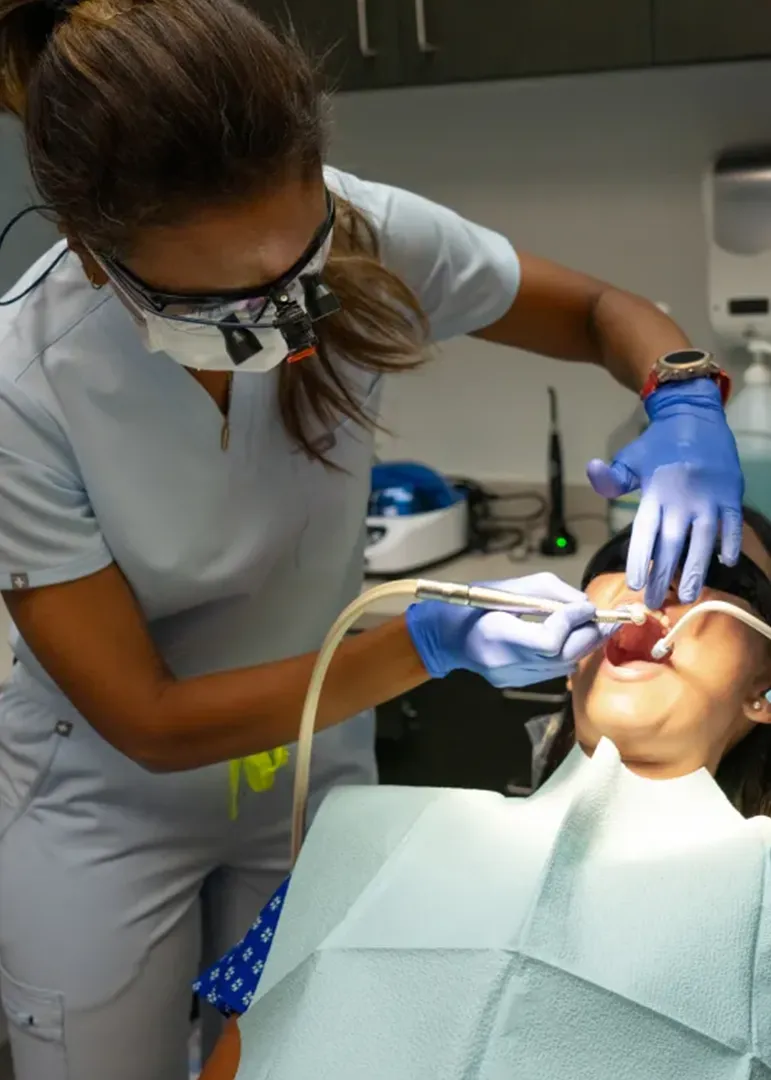 Dr. Isra Ahmed with a patient Dr. Isra Ahmed with a patient, cleaning her teeth