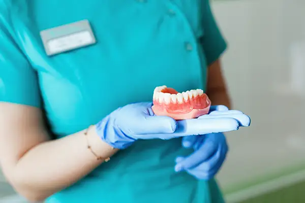 Removable overdenture snapping onto implant attachments for secure fit